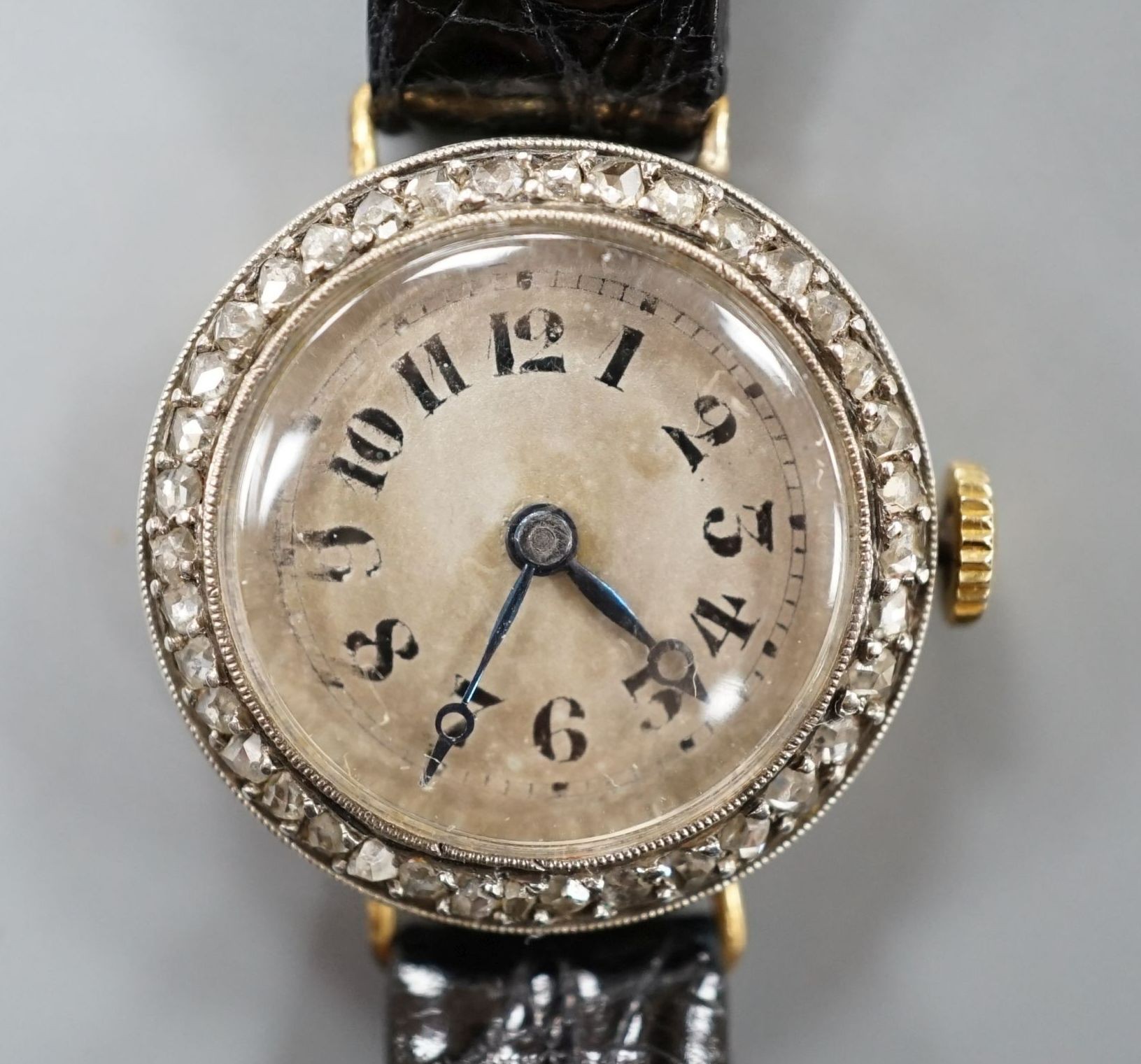 A lady's early 20th century 18k and diamond set manual wind wrist watch, on later leather strap